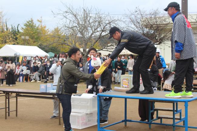 お楽しみ抽選会で賞品を受け取っている様子