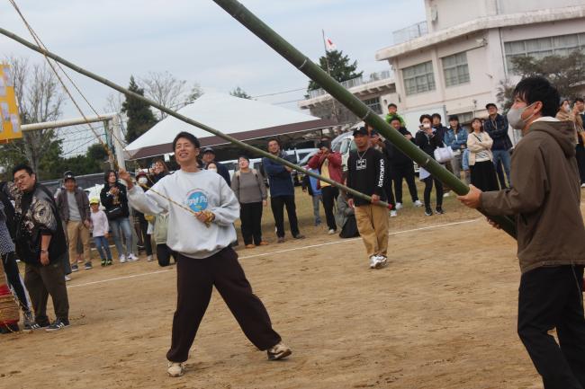 提灯祭りの竹を支える保護者