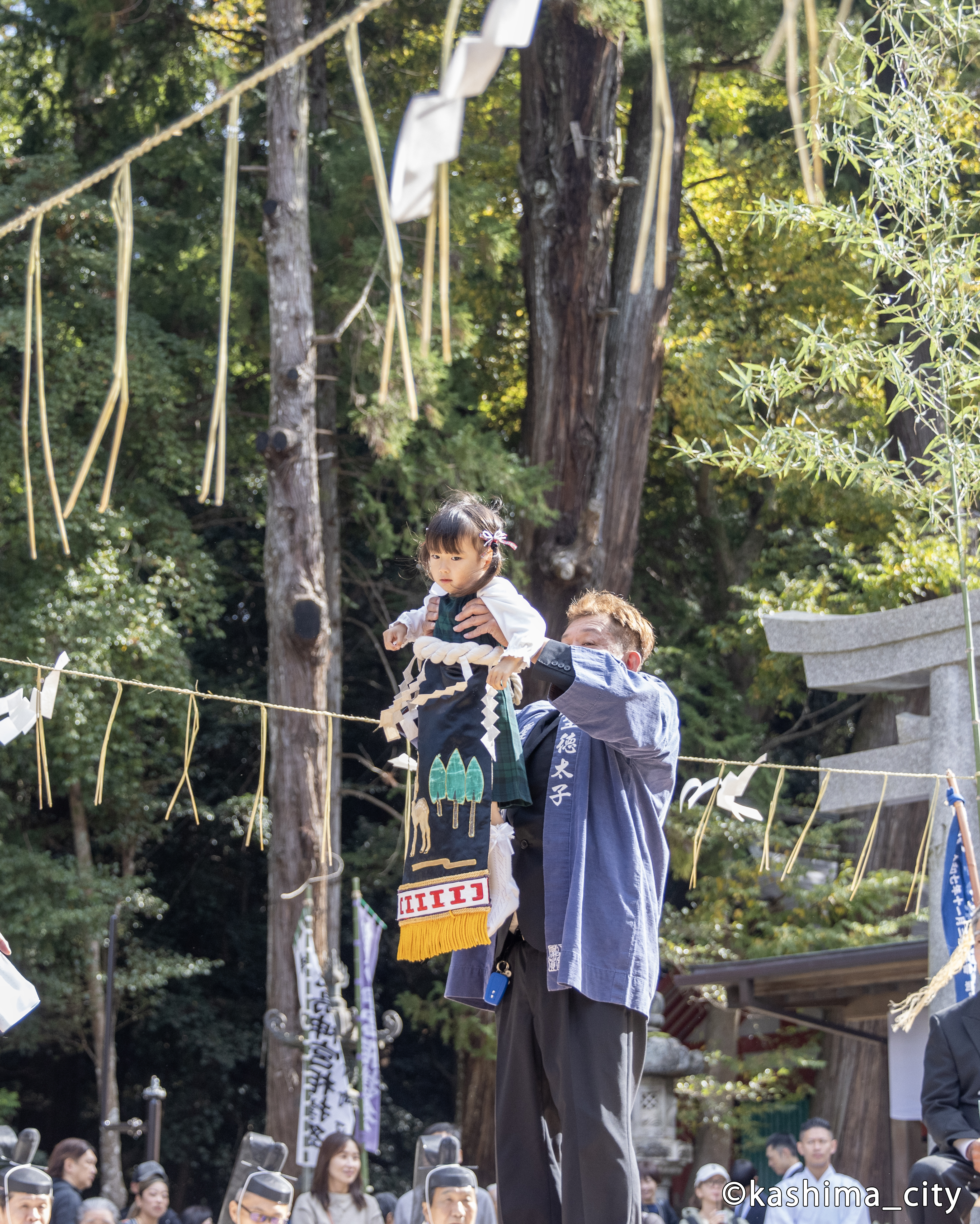 高く持ち上げられて観客に紹介される女の子の豆力士