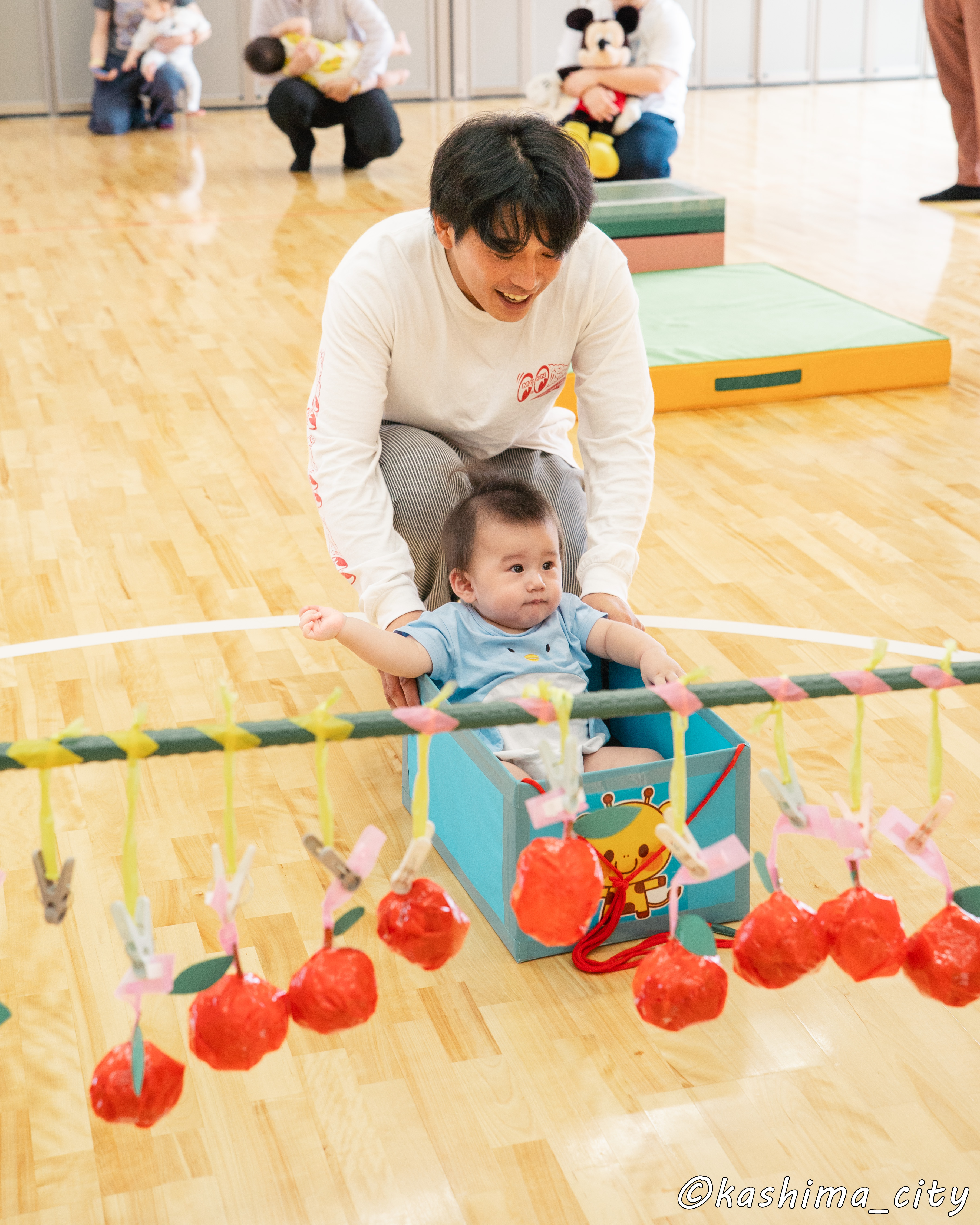 ボックスに入ってお父さんに運んでもらうお子さん